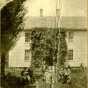 Black and white photograph of the Reverend Bernt J. Muus and family outside of Holden Parsonage in Kenyon, c.1875.