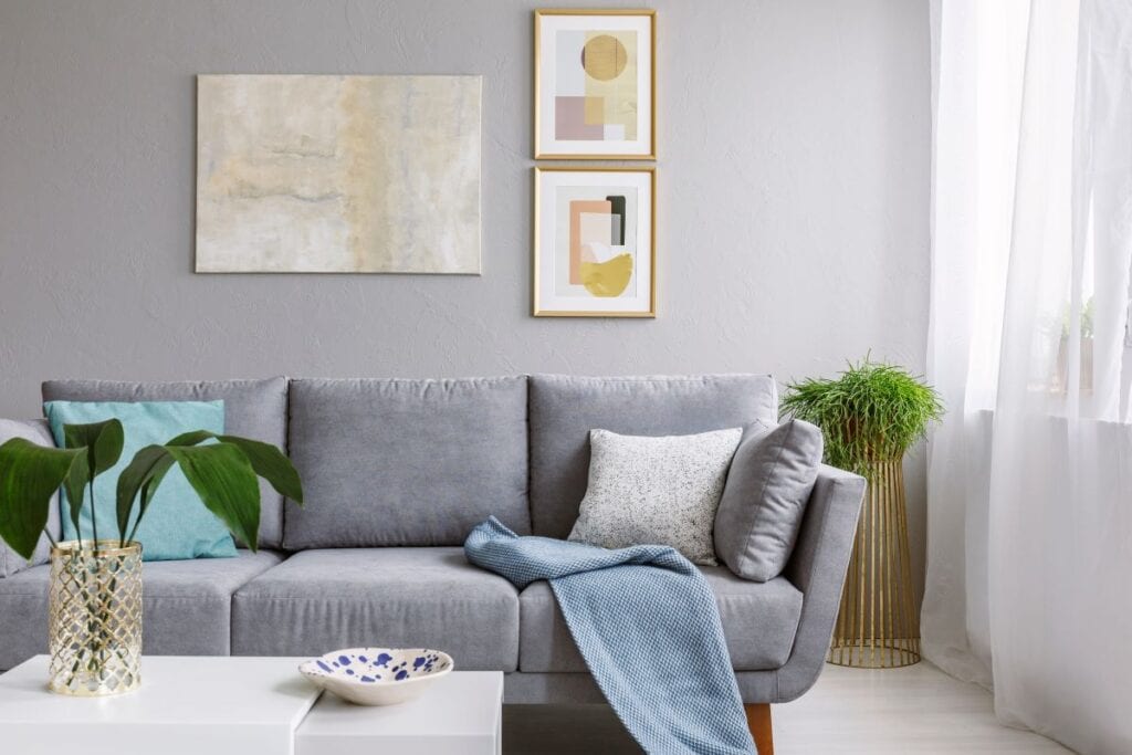 Modern living room with gray couch and art on the wall