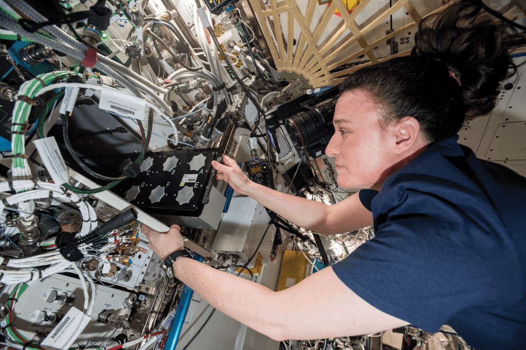 image of an astronaut working with an experiment