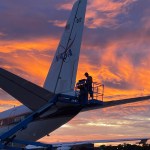 Sunset view of the DC-8 parked on the tarmac is getting inspected.