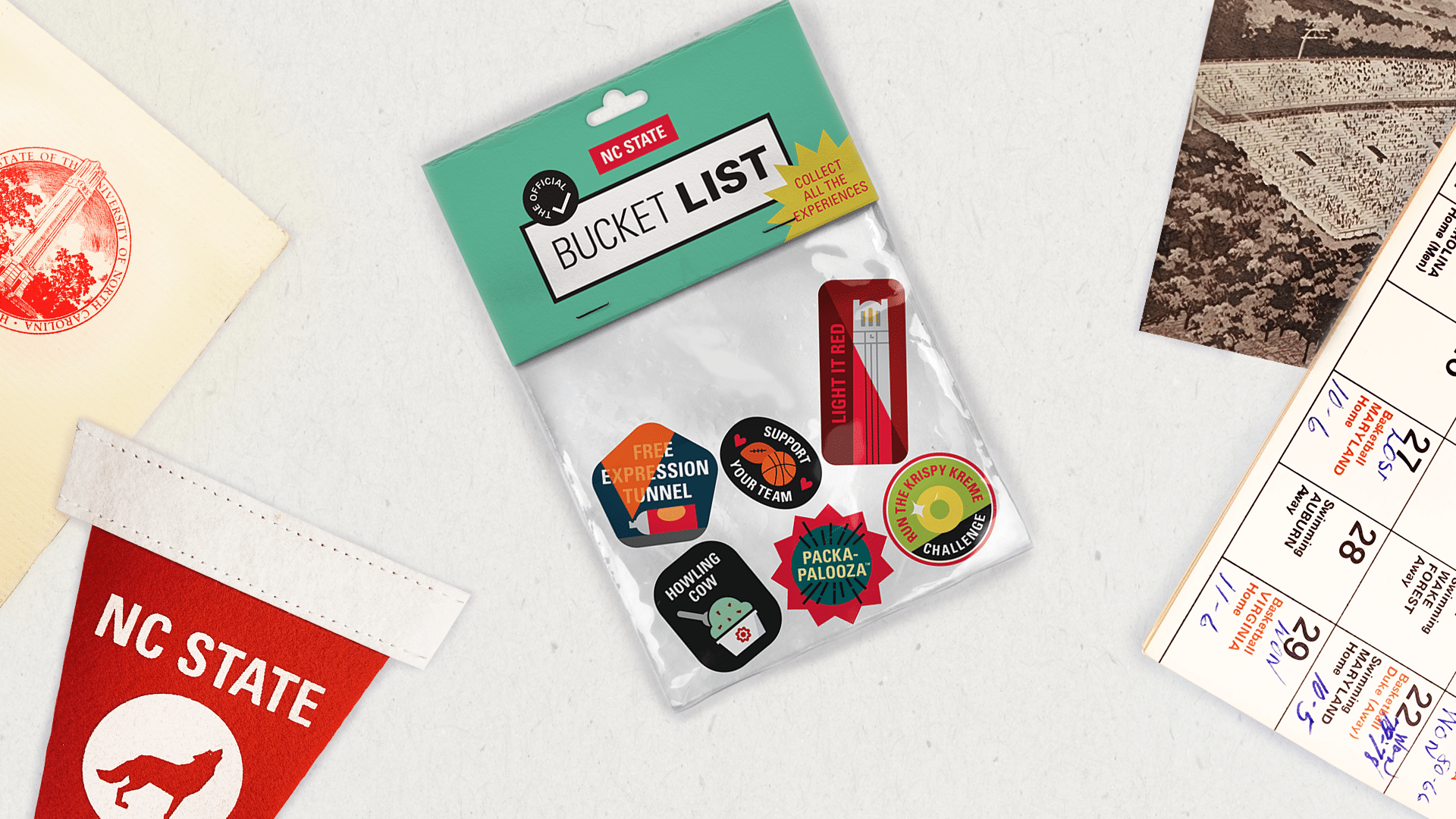 A plastic bag labeled "The Official NC State Bucket List," filled with stickers that represent different bucket list items.