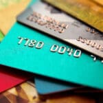 stack of multicolored credit cards, close up view with selective focus