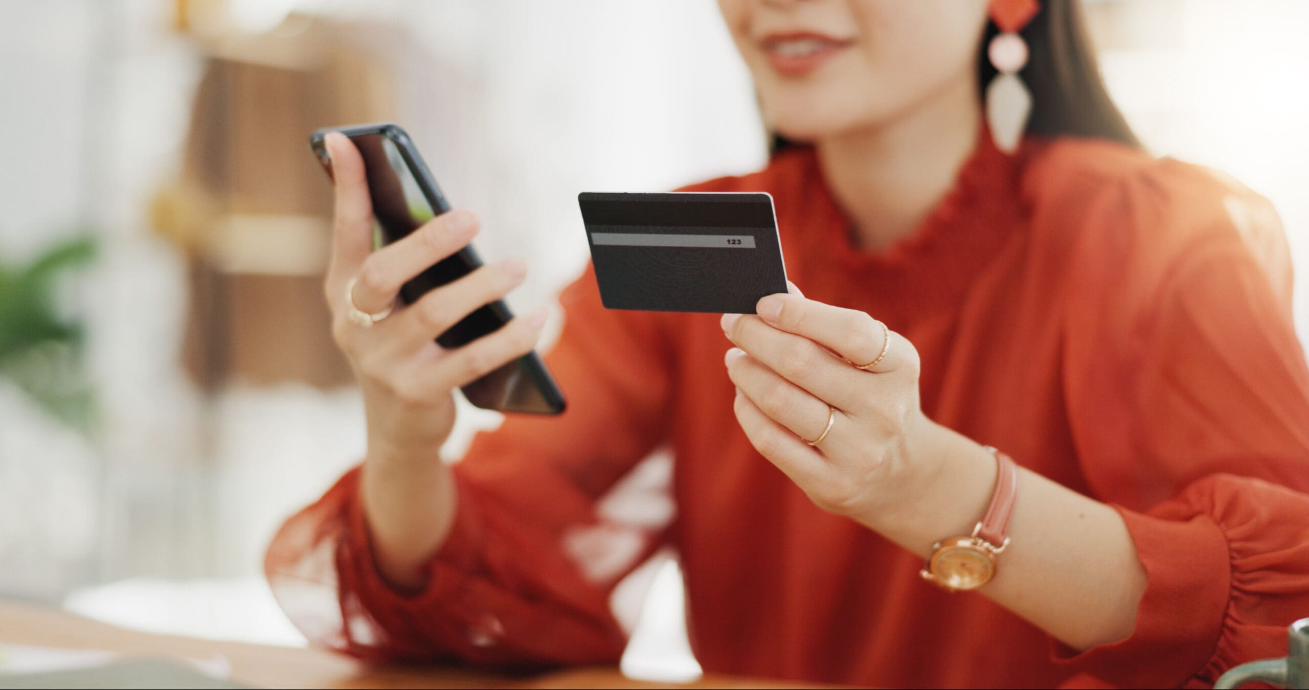 Happy woman, credit card and phone for business online shopping, trading or fintech payment in office startup. Asian fashion person with bank information on cellphone for website loan or transaction