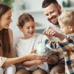 Parents Teaching Kids Savings Habits With Piggy Bank