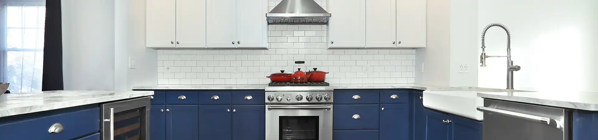 Photo of kitchen with blue and white refinished cabinets