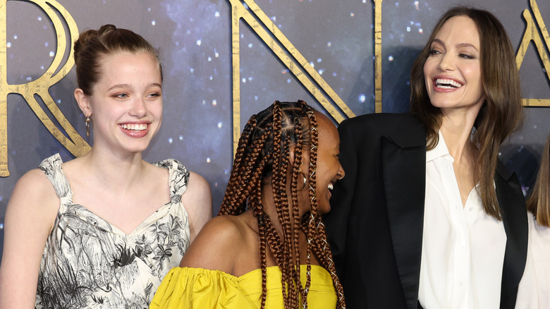 Shiloh Jolie-Pitt, Zahara Jolie-Pitt, and Angelina Jolie smiling 