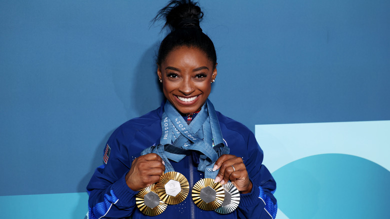 Simone Biles wearing medals