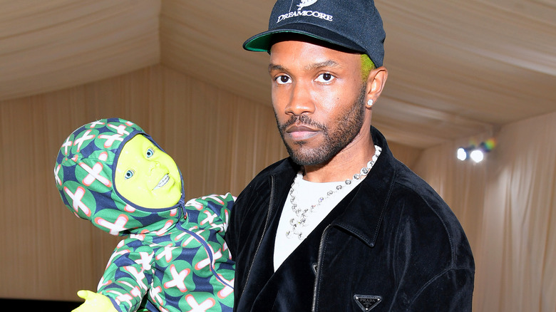 Frank Ocean holding bright green baby