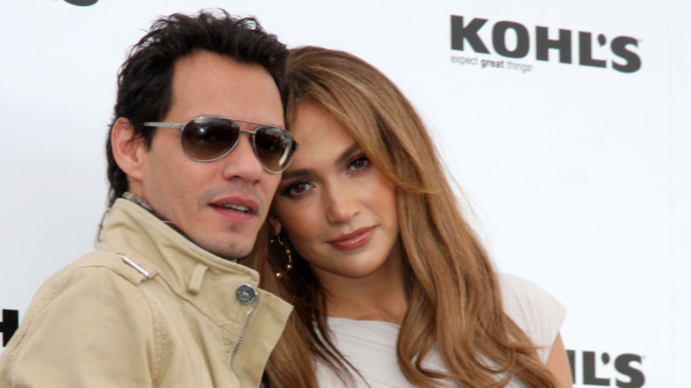 Jennifer Lopez leaning on Marc Anthony