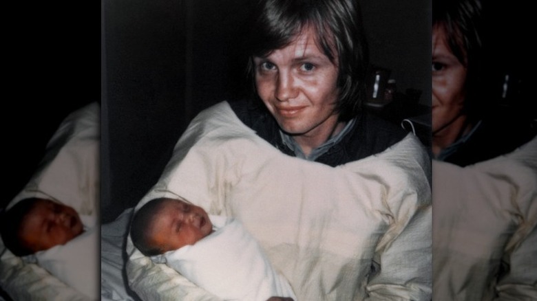 Polaroid of Jon Voight holding baby Angelina Jolie