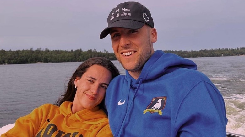 Caitlin Clark and Connor McCaffery posing together on a boat