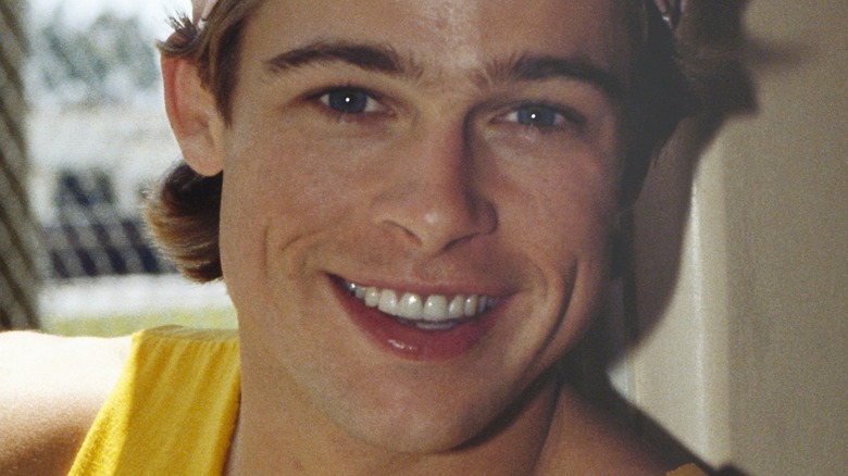 Brad Pitt in a tank top, smiling