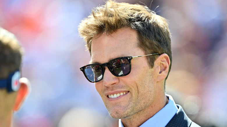 Brady smiles on the sidelines during one of his first broadcasts.