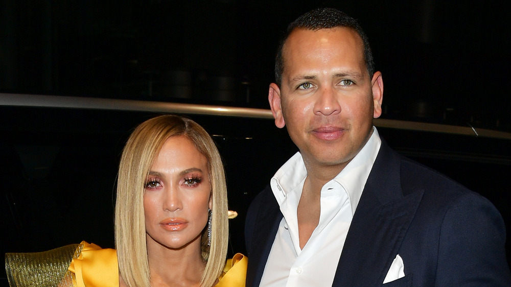 Jennifer Lopez and Alex Rodriguez looking serious at an event