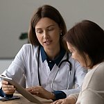 Image of a doctor reviewing a medical report with a patient