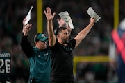 Eagles offensive coordinator Kellen Moore (left) called a pass play late in Sunday's win  against the Cleveland Browns.