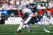 Cincinnati Bengals wide receiver Ja'Marr Chase (left) is tackled by Eagles cornerback Cooper DeJean during Sunday's game.