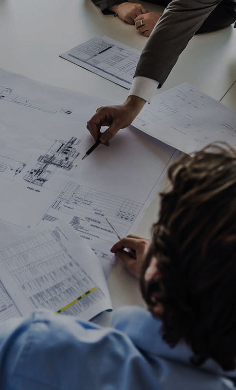 People reviewing plans at a table