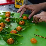 Person cooking with tomatoes and basil