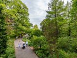 Visitors walking along the ECAG path with green trees surrounding them