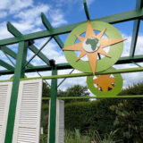 A view of a gazebo awning in green and gold with the silhouette of the African continent displayed