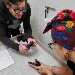 Garth Johnson and Natasha Smoke-Santiago discuss a Haudenosaunee pipe from Onondaga homeland.