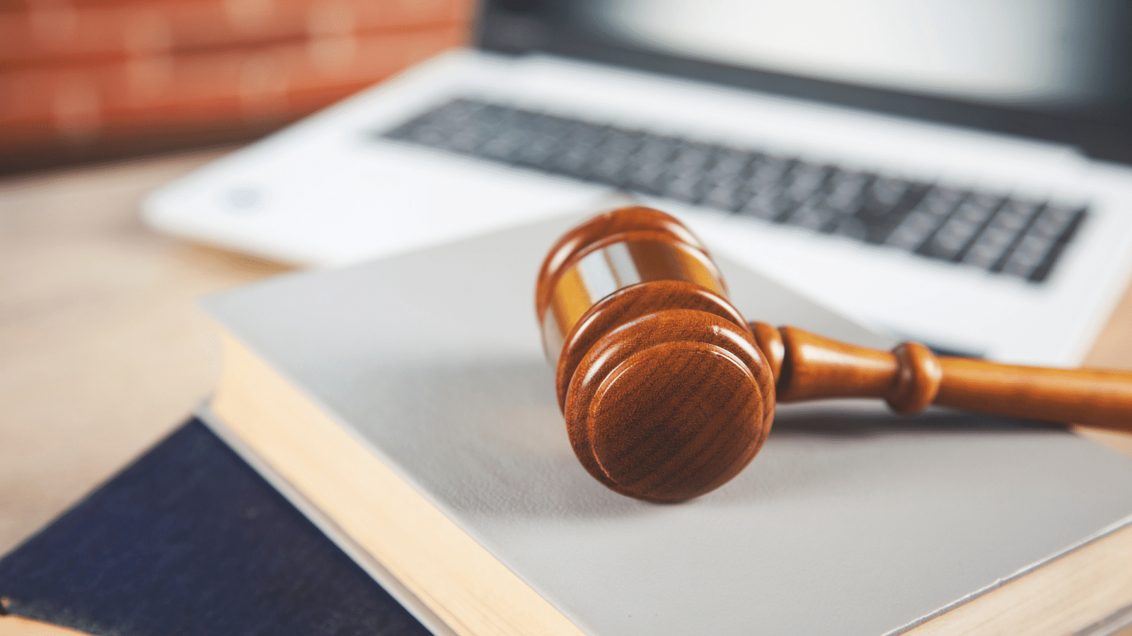 gavel on a book in front of a laptop