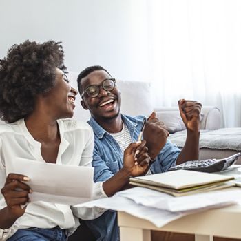 A couple celebrates paying off a credit card.