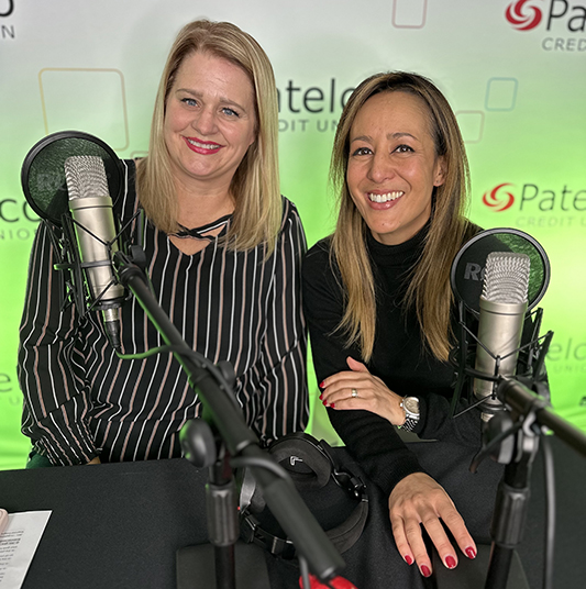 Patelco employees Michele Enriquez and Jennifer Mink at the podcask desk