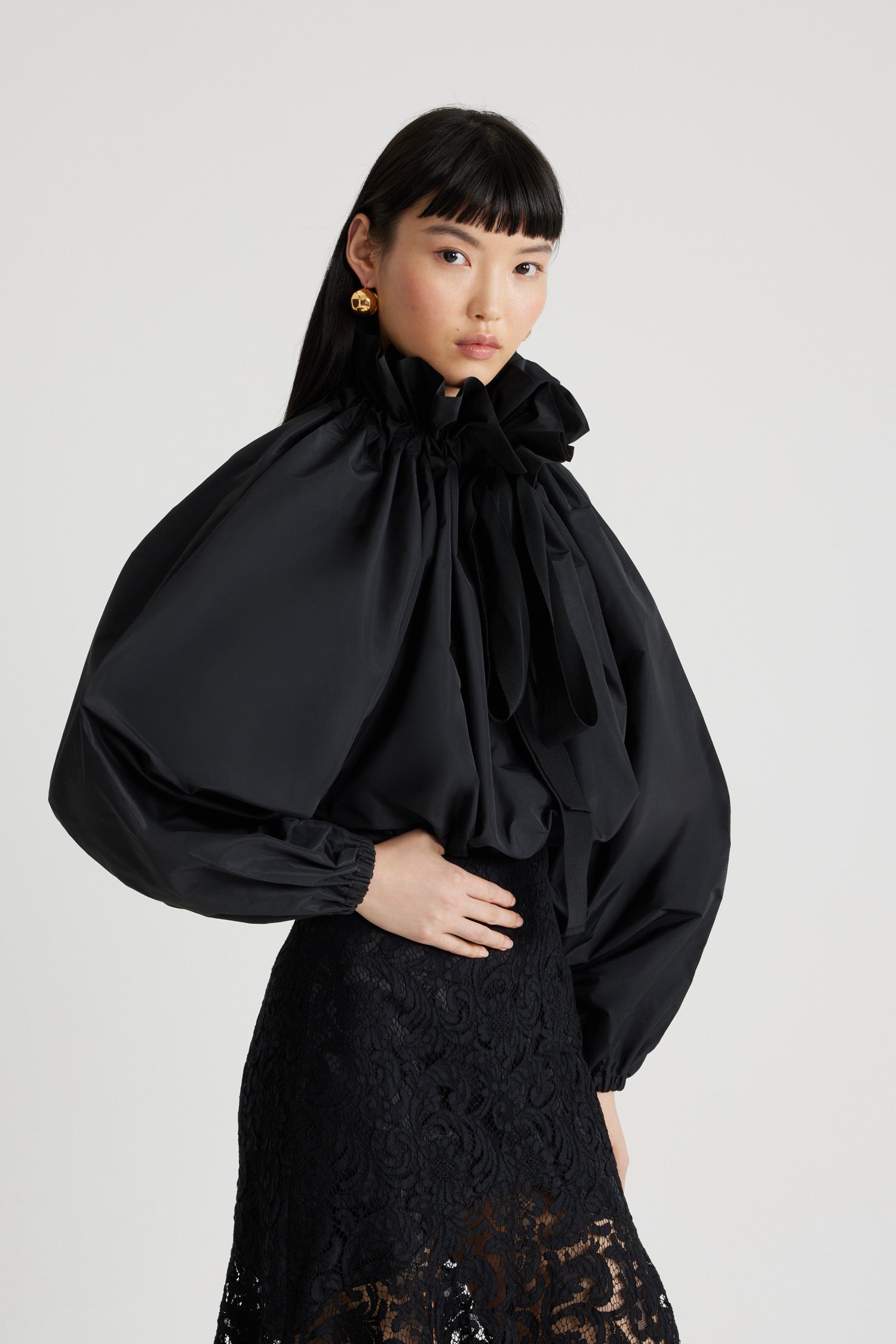 Patou - Grosgrain puff sleeve faille top - Black - An everyday proposition of bold sleeves and couture ribbons.Black recycled polyester faille top. High volume silhouette. Drawstring collar with ruching and grosgrain. Batwing sleeves with elasticated cuffs. Elasticated waist.