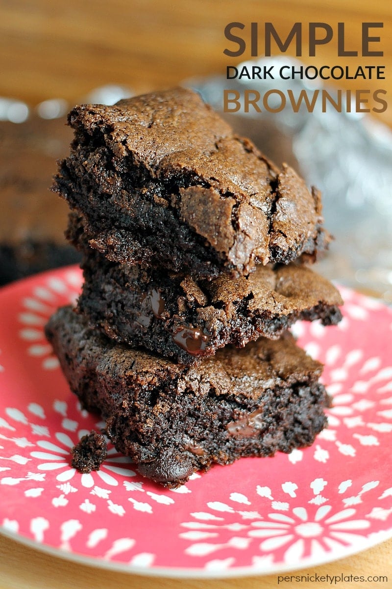 stack of homemade dark chocolate brownies on a red plate