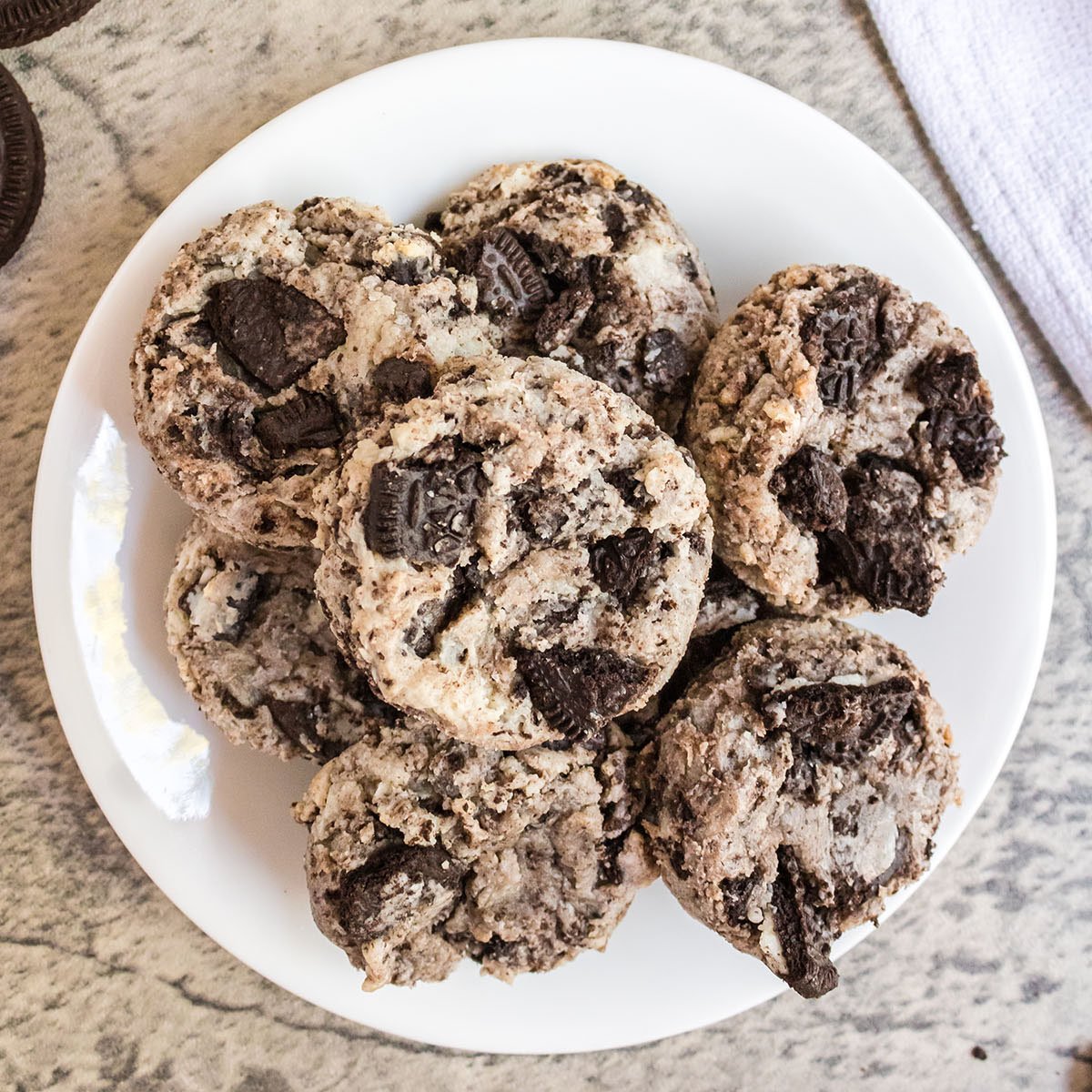 overhead shot of white plate filled with oreo cheesecake cookies.