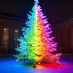 A Christmas tree with rainbow colored lights and decorations.