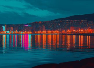 A night scene of a city waterfront 4K image with reflections of city lights dancing on the water.