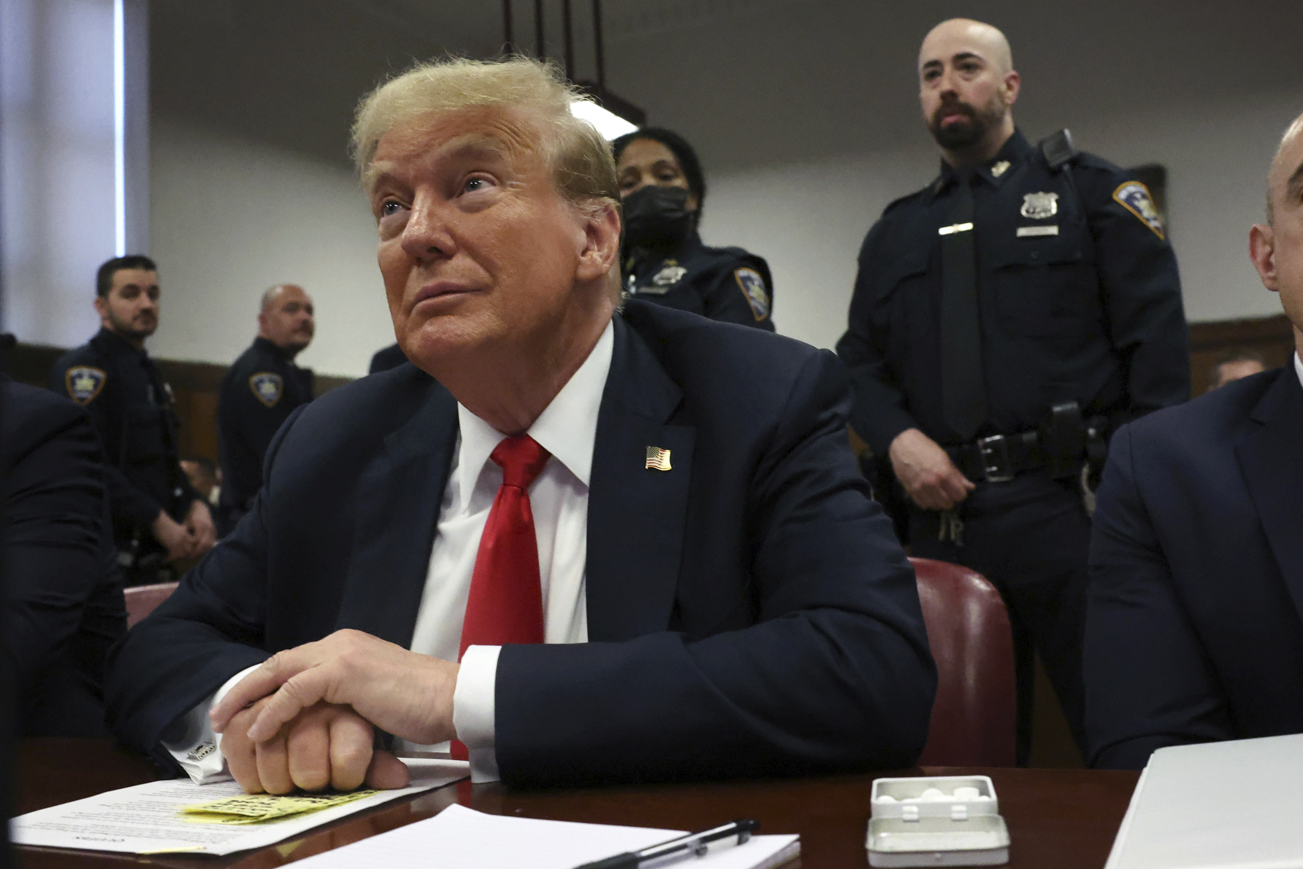 Former U.S. President Donald Trump sits in court.