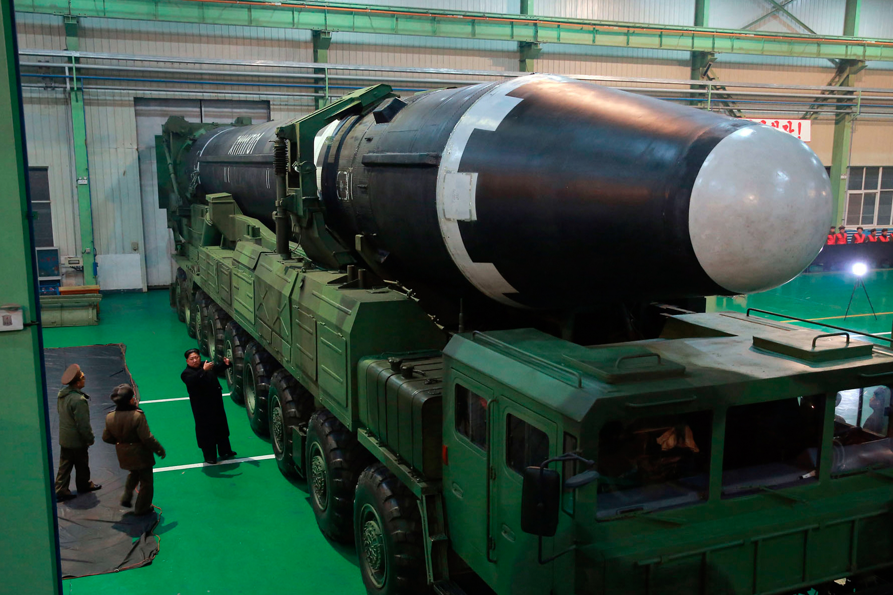 North Korean leader Kim Jong Un standing beside the Hwasong-15 intercontinental ballistic missile.