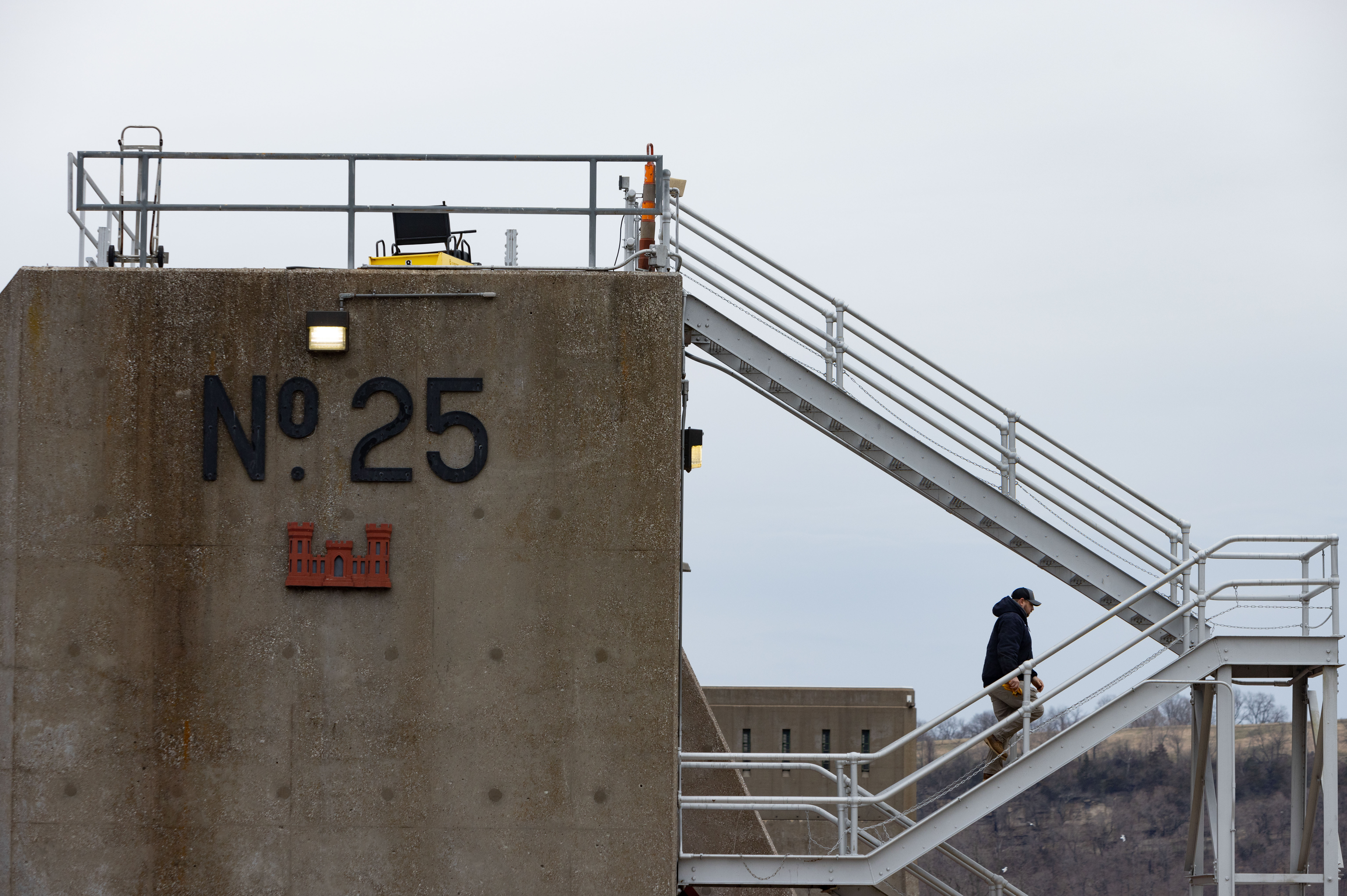 Shift chief Nick Dowling climbs the dam to adjust water levels at Lock 25