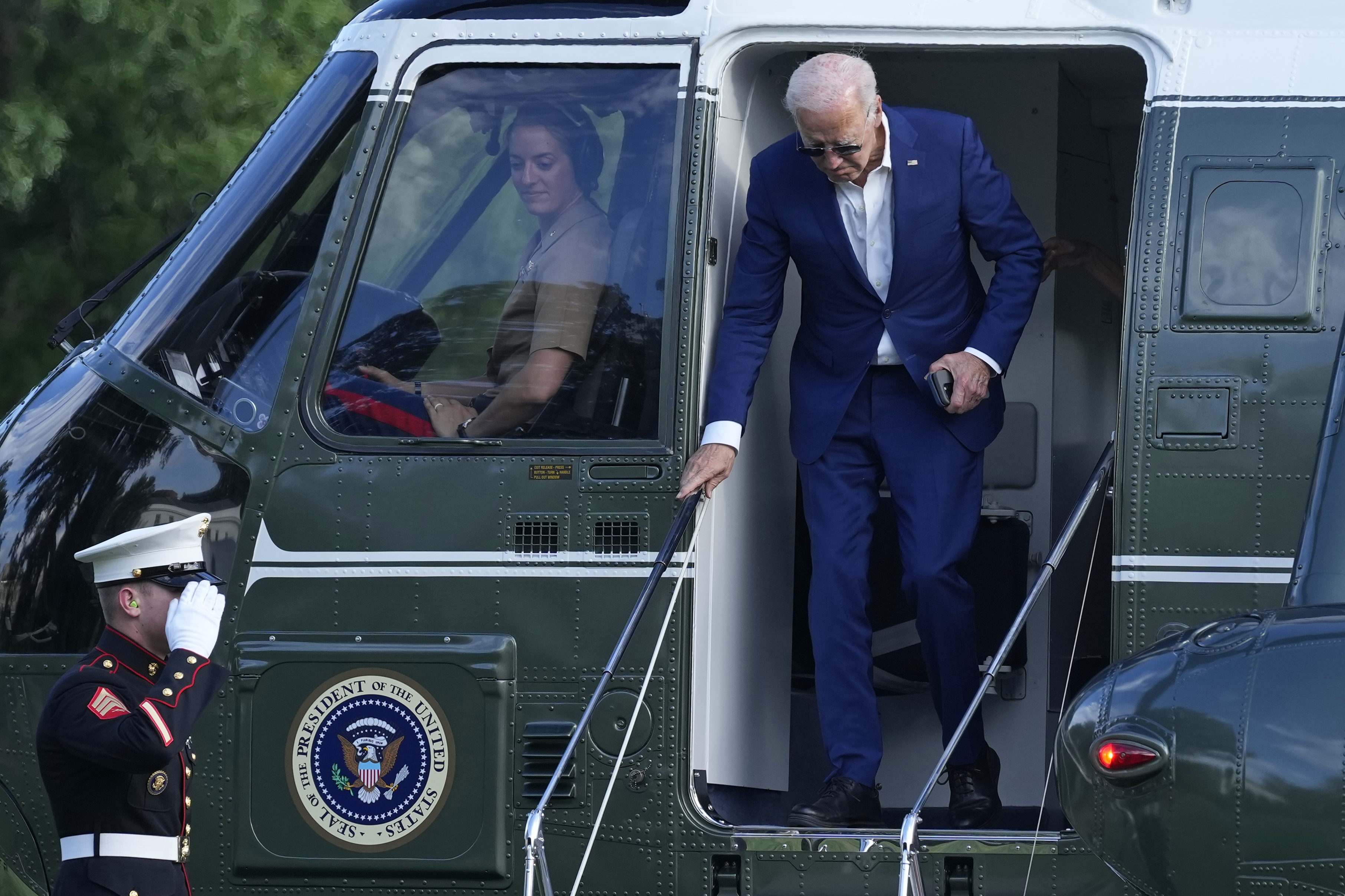 President Joe Biden walks off of Marine One on the South Lawn of the White House.