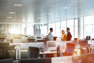 photo - Three Work Colleagues Talking in Open Office