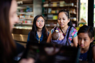 photo - Mother and Daughters at Check Out Counter