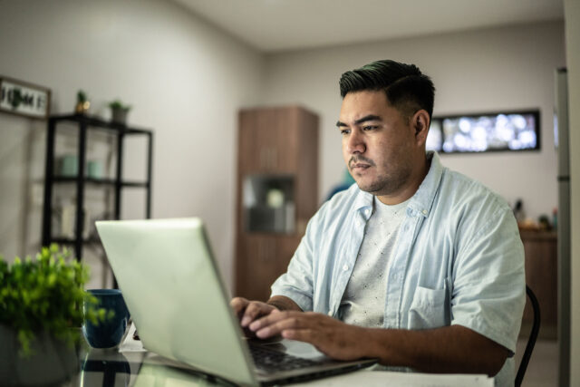 photo - Man Using Laptop at Home