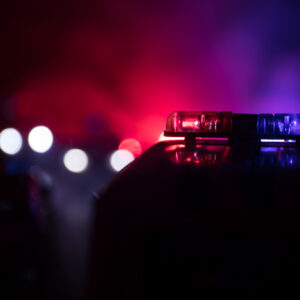 photo - Police Car Chasing a Car at Night