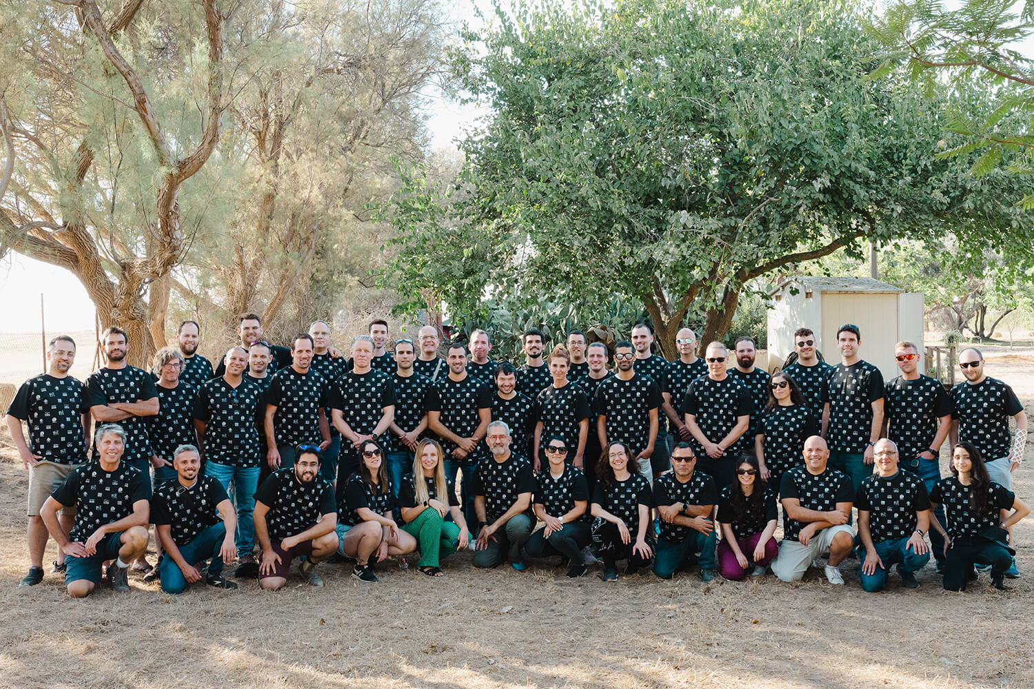 Group photo of company employees in black shirts