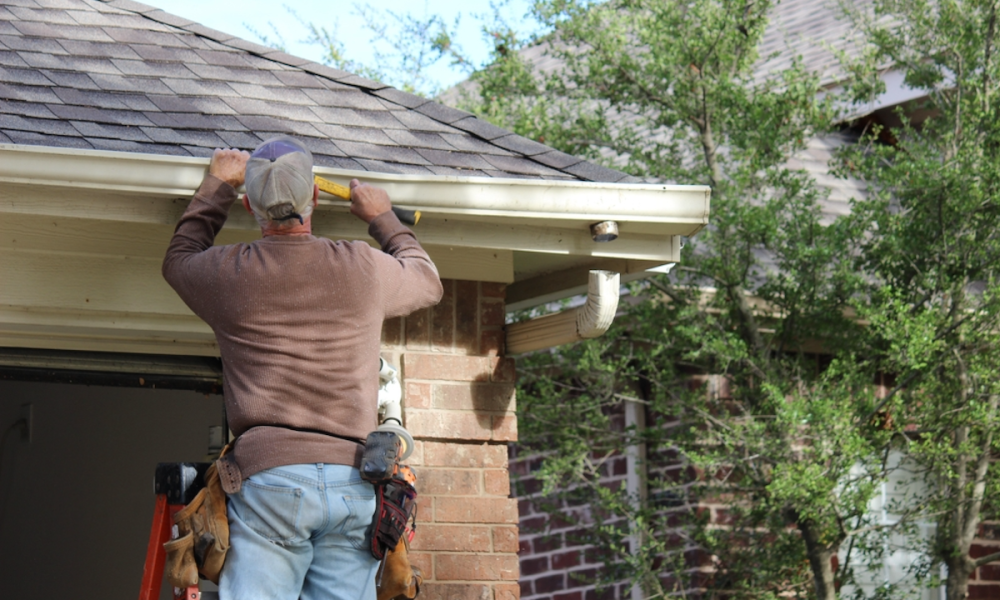 man working on house exterior