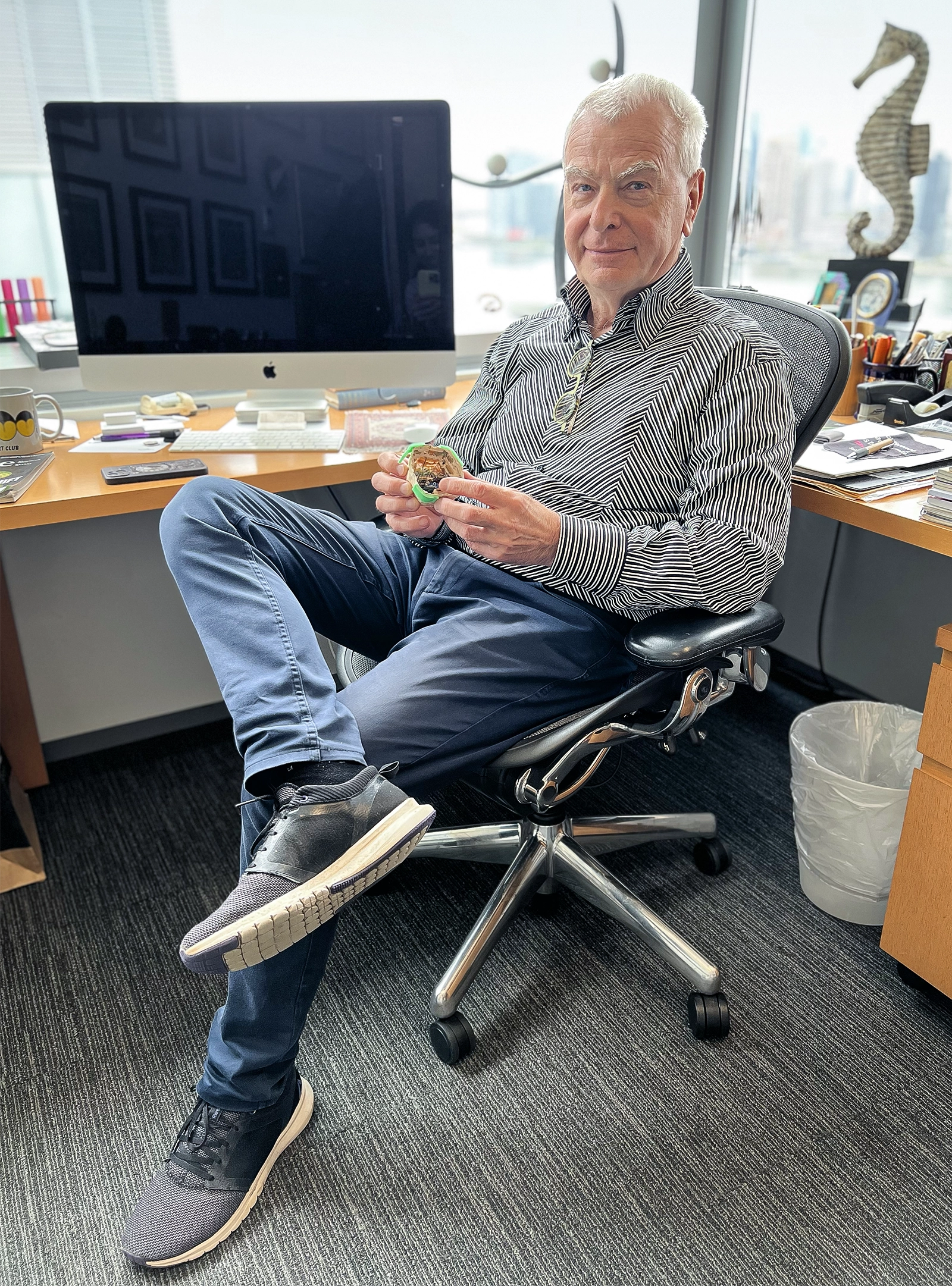 György Buzsáki sits on a chair in his office at New York University.