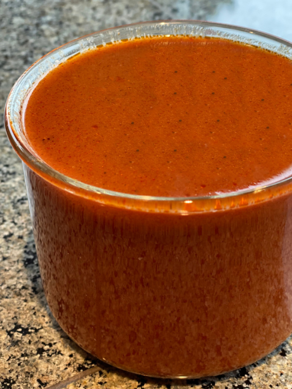 Enchilada sauce in glass jar on counter