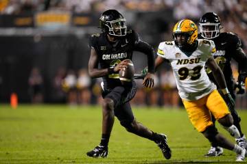 Colorado quarterback Shedeur Sanders runs against North Dakota State during an NCAA college foo ...