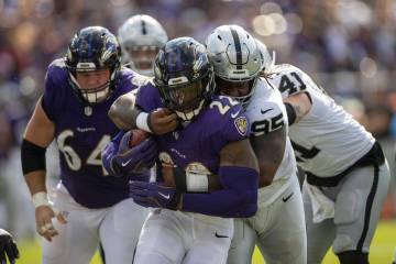 Raiders defensive tackle John Jenkins (95) tackles Baltimore Ravens running back Derrick Henry ...