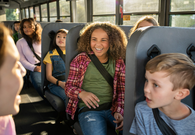 Children sitting in a Zum bus