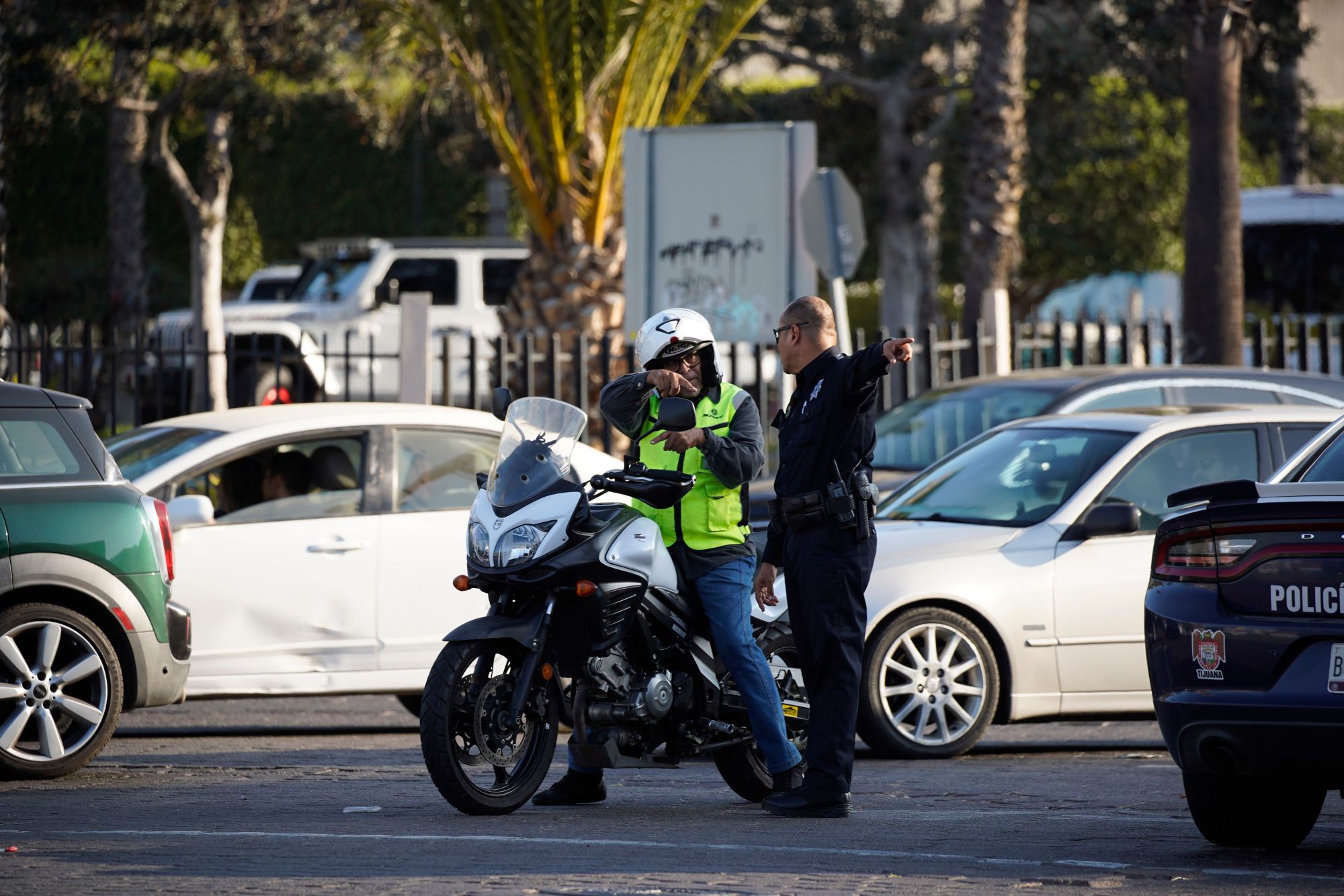 A widespread Microsoft outage disrupted traffic flow at the US/Mexico Border. Traffic went on for miles south of the border. A police officer points to the traffic in Zona Rio on Friday, July 19, 2024 in Tijuana, Baja California. (Alejandro Tamayo / The San Diego Union-Tribune)